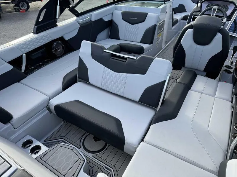 Slide: The Image of 2022 MasterCraft XT23 boat interior with luxurious seating and modern design. - 14
