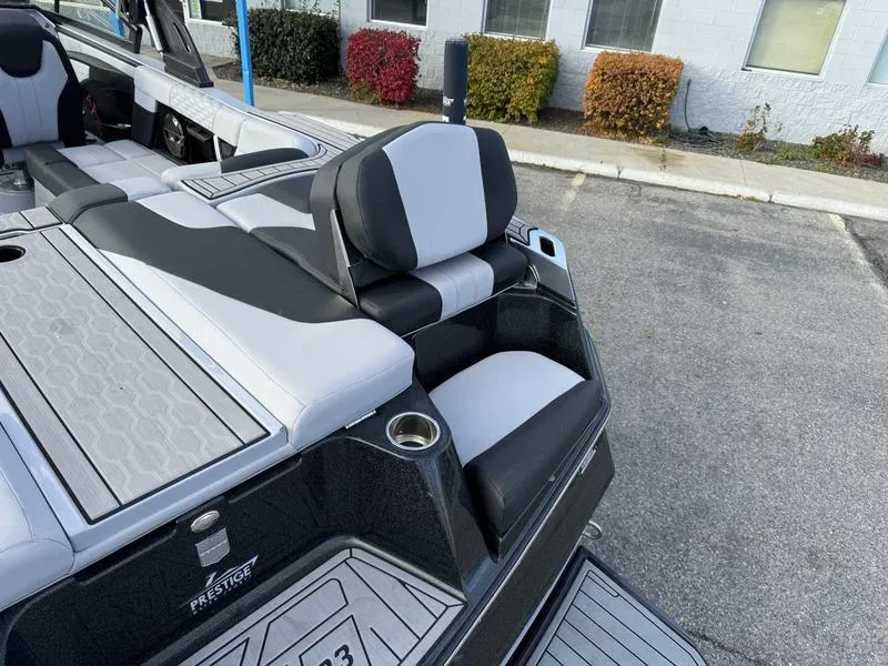 Slide: The Image of 2022 MasterCraft XT23 boat interior with sleek seating and modern design. - 16