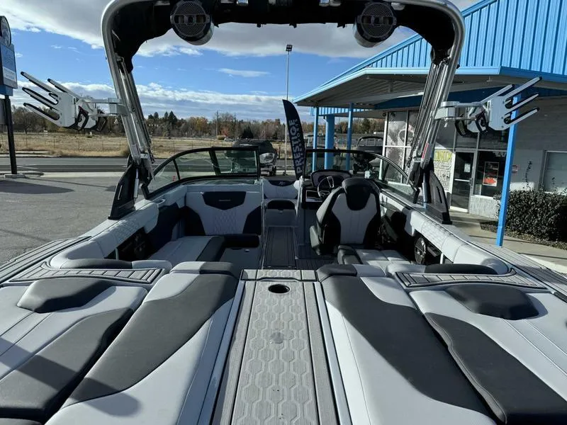 Slide: The Image of 2022 MasterCraft XT23 boat interior with sleek seating and modern design. - 7