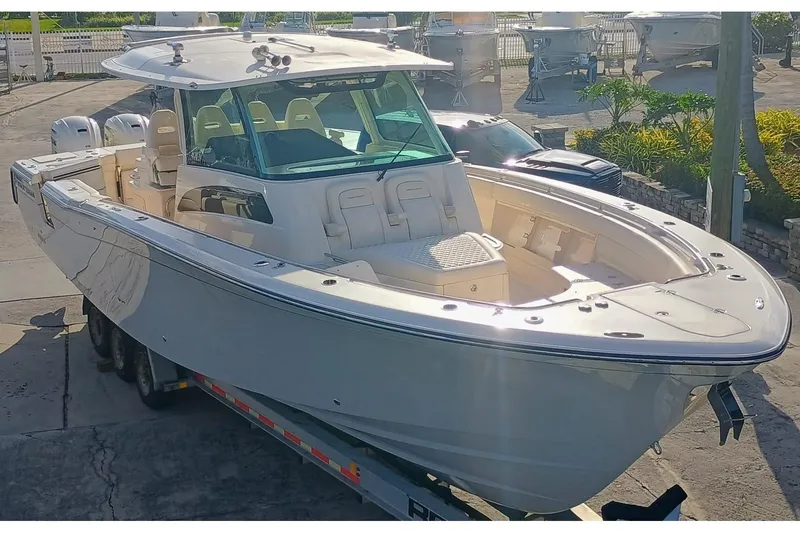 Slide: The Image of 2025 Grady-White Canyon 386 boat on trailer, docked in marina. - 1