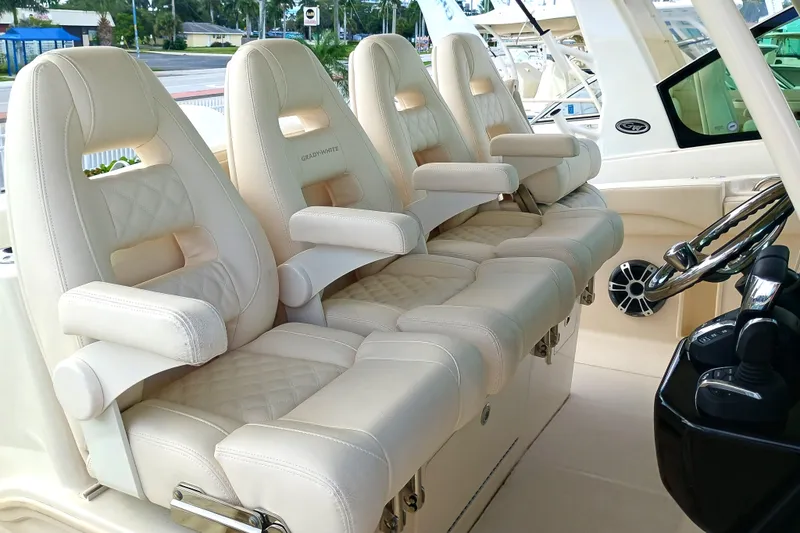 Slide: The Image of Luxurious seating on 2025 Grady-White Canyon 386 boat, featuring plush, cream-colored captain's chairs. - 12