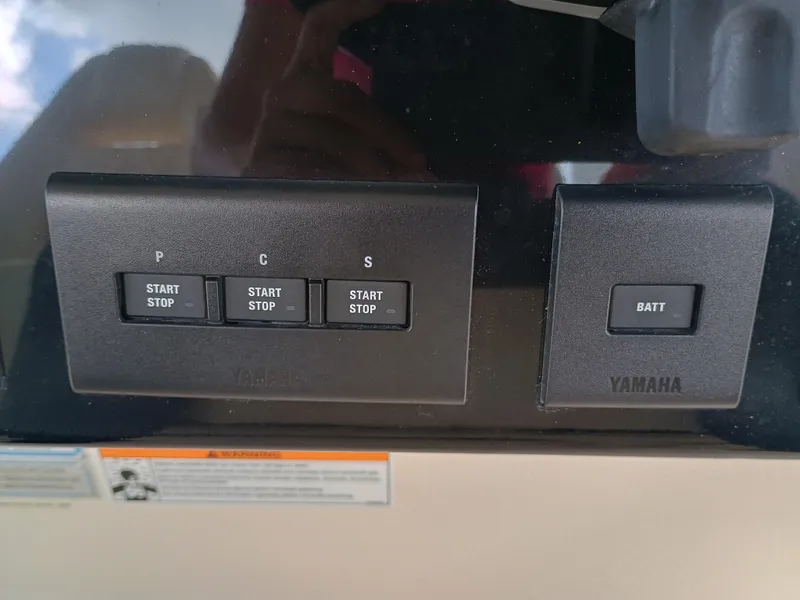 Slide: The Image of Control panel of a 2025 Grady-White Canyon 386 boat with Yamaha start-stop buttons. - 17