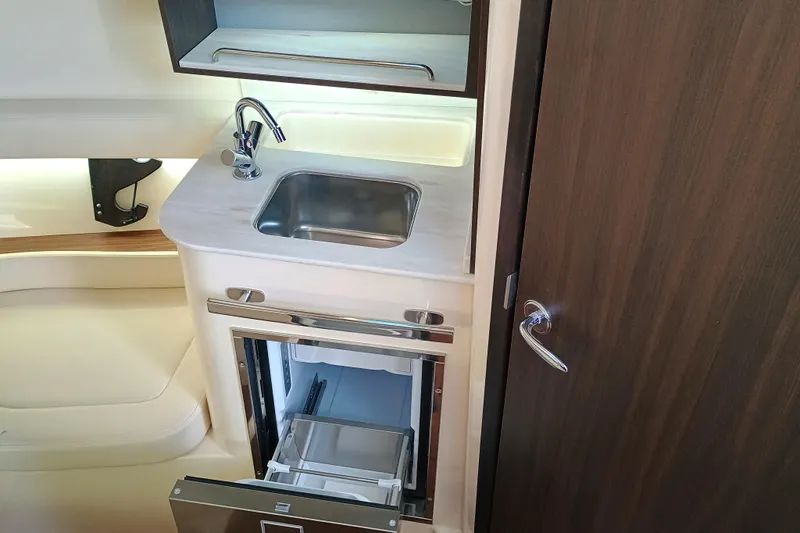 Slide: The Image of 2025 Grady-White Canyon 386 interior with sink and storage, featuring modern design. - 26