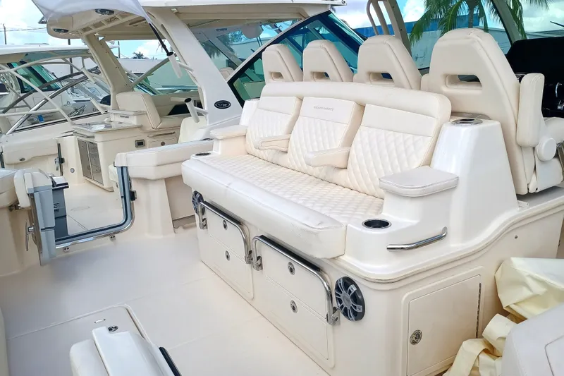 Slide: The Image of Luxurious seating on a 2025 Grady-White Canyon 386 boat, featuring elegant white upholstery. - 27
