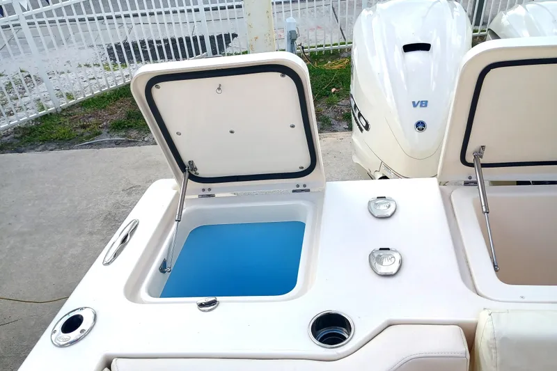 Slide: The Image of 2025 Grady-White Canyon 386 boat with open storage compartments and V8 engine. - 28