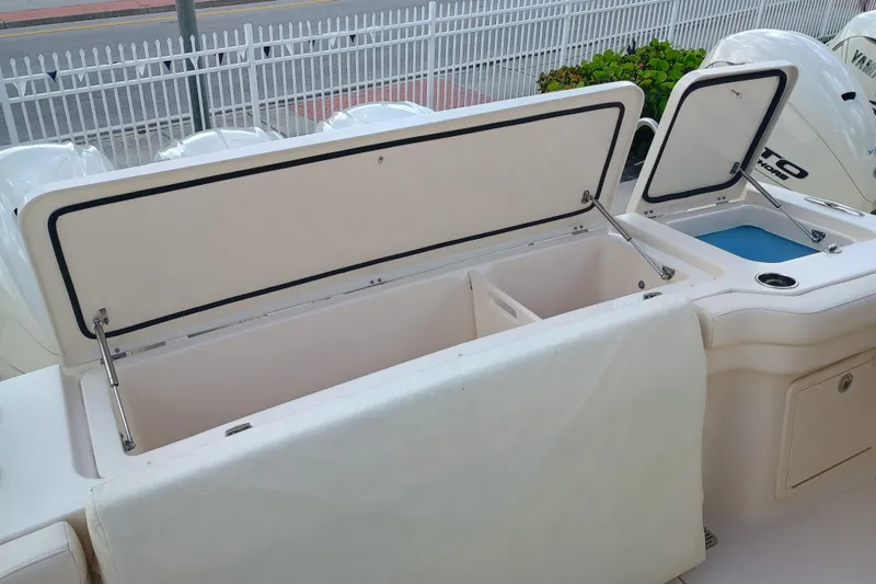Slide: The Image of 2025 Grady-White Canyon 386 boat with open storage compartments and Yamaha outboard engines. - 29