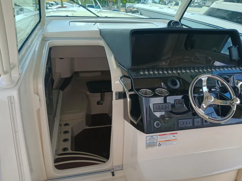 Slide: The Image of 2025 Grady-White Canyon 386 helm with modern controls and cabin entrance. - 31