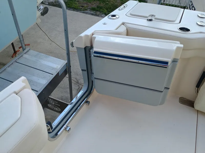 Slide: The Image of 2025 Grady-White Canyon 386 boat interior with open side door and seating area. - 33