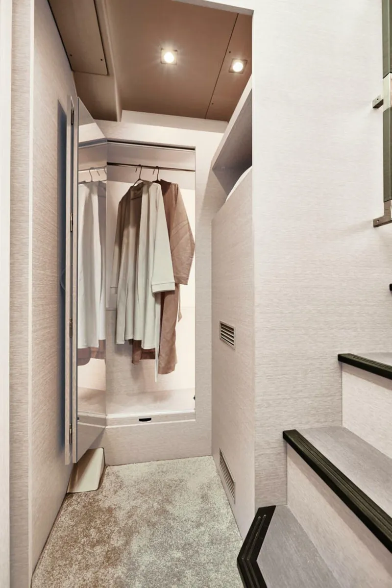 Slide: The Image of Interior of 2025 Prestige 420S yacht, featuring a modern closet and staircase. - 13