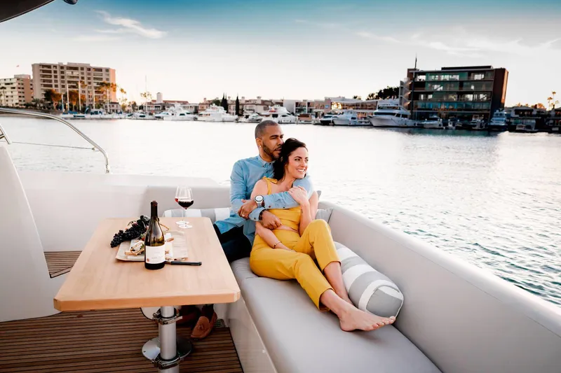 Slide: The Image of Couple relaxing on a 2025 Prestige 420S yacht, enjoying wine by the waterfront. - 6