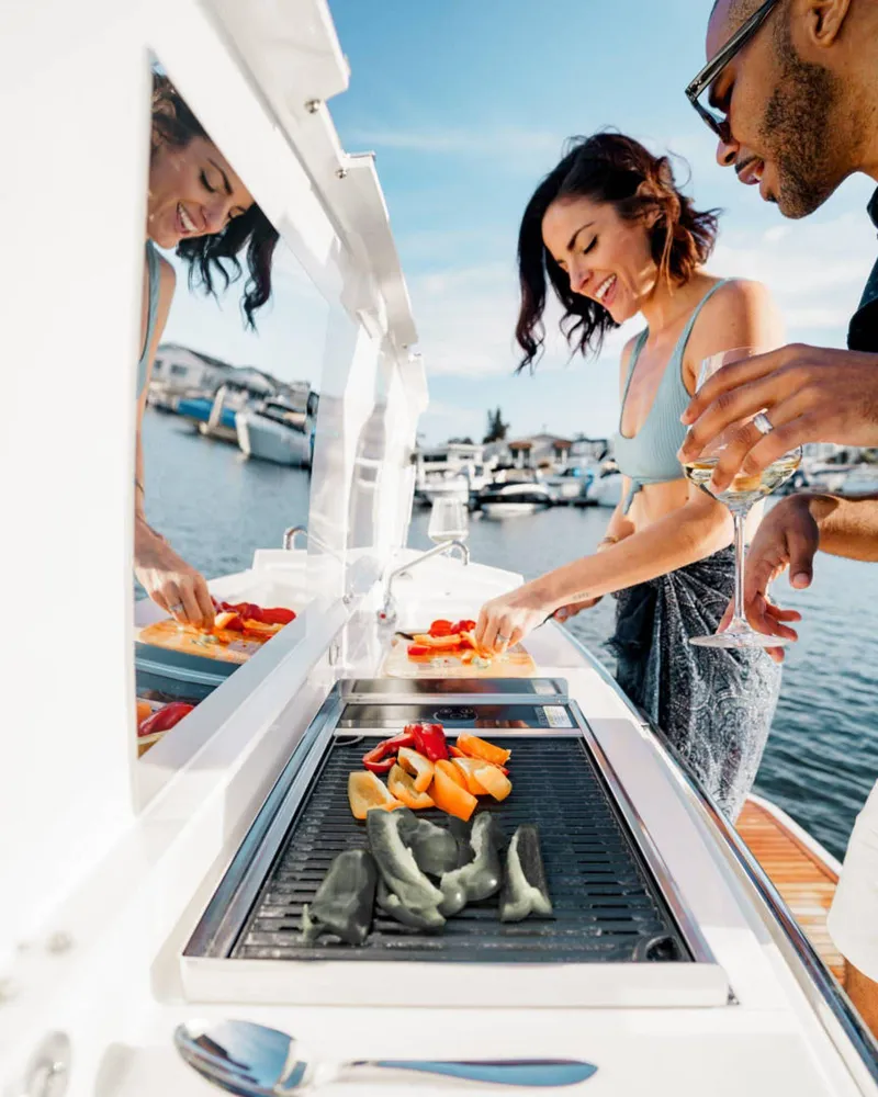 Slide: The Image of Couple enjoying a barbecue on a 2025 Prestige 420S yacht, with marina views. - 7