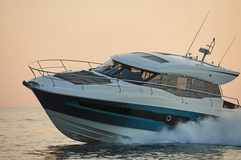 The Image of 2023 Prestige 460S yacht cruising on calm waters at sunset. - 0