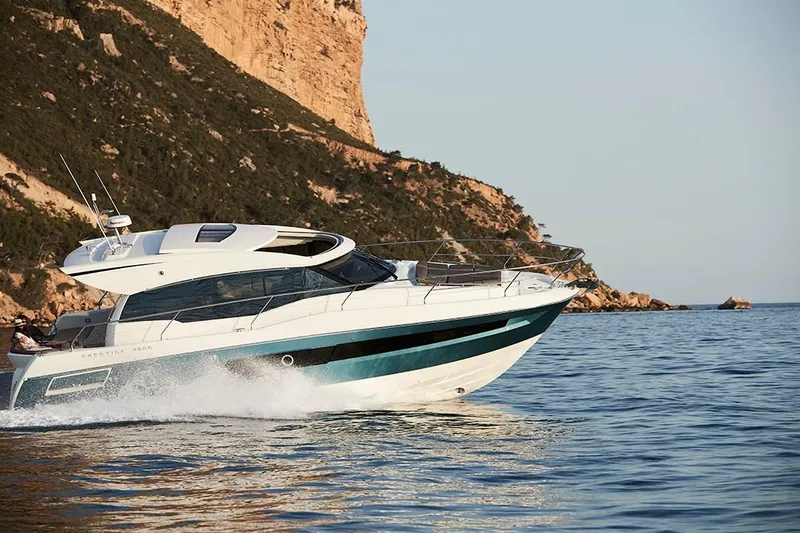 Slide: The Image of 2023 Prestige 460S yacht cruising near rocky coastline. - 8