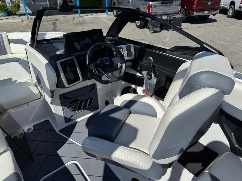 Slide: The Image of 2024 Malibu Wakesetter 23 LSV boat interior with modern dashboard and seating. - 10