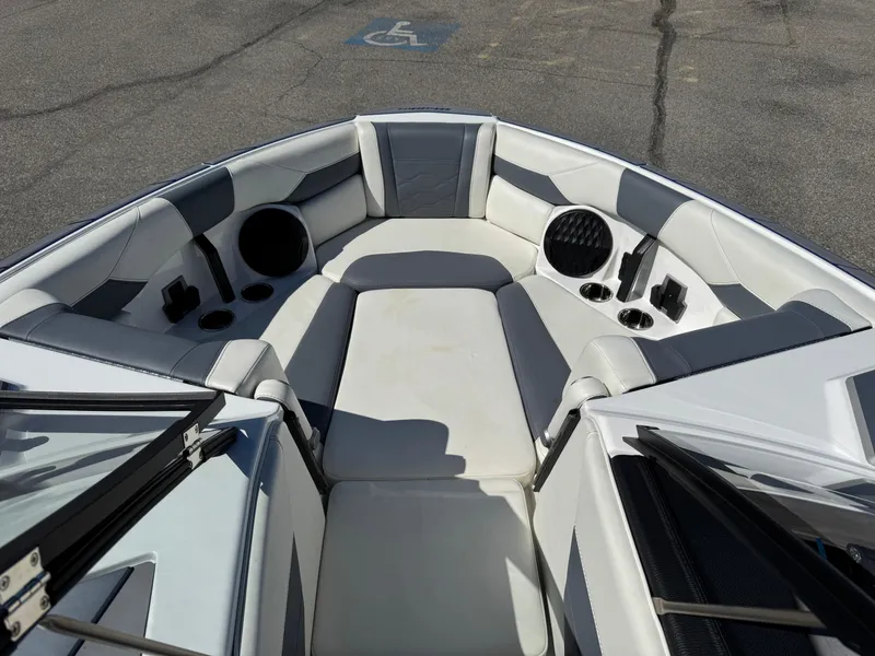Slide: The Image of 2024 Malibu Wakesetter 23 LSV boat interior with cushioned seating and cup holders. - 12