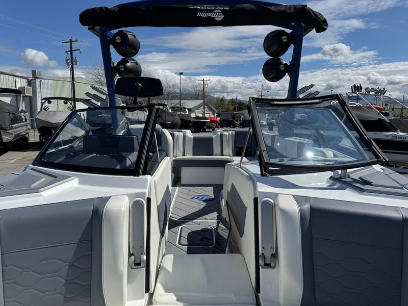 Slide: The Image of 2024 Malibu Wakesetter 23 LSV boat interior with dual windshields and seating. - 13