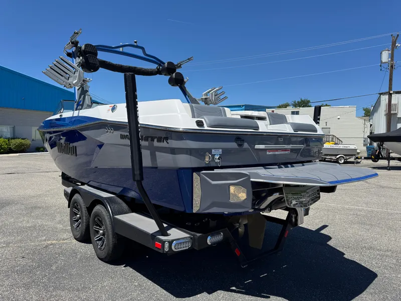 Slide: The Image of 2024 Malibu Wakesetter 23 LSV boat on trailer, parked outdoors under clear blue sky. - 5
