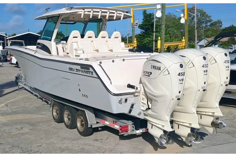 Slide: The Image of 2025 Grady-White Canyon 386 boat with triple Yamaha 450 V8 engines on a trailer. - 14
