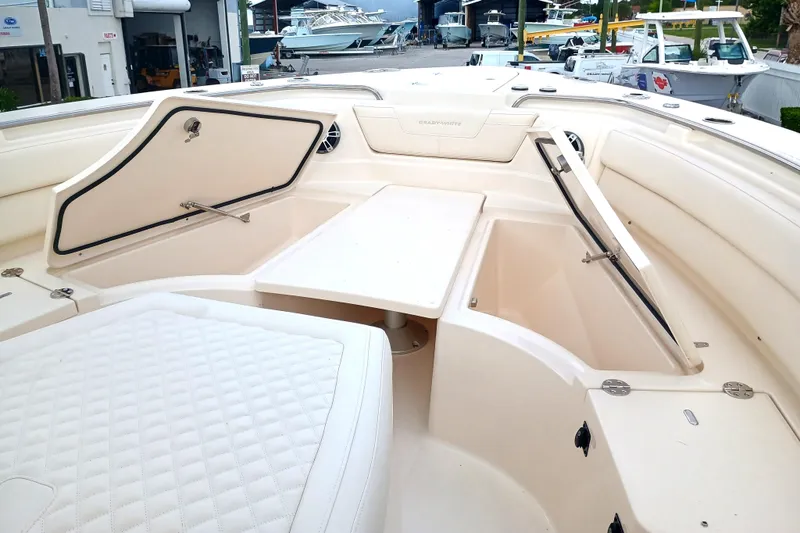 Slide: The Image of 2025 Grady-White Canyon 386 boat interior with open storage compartments and seating. - 15