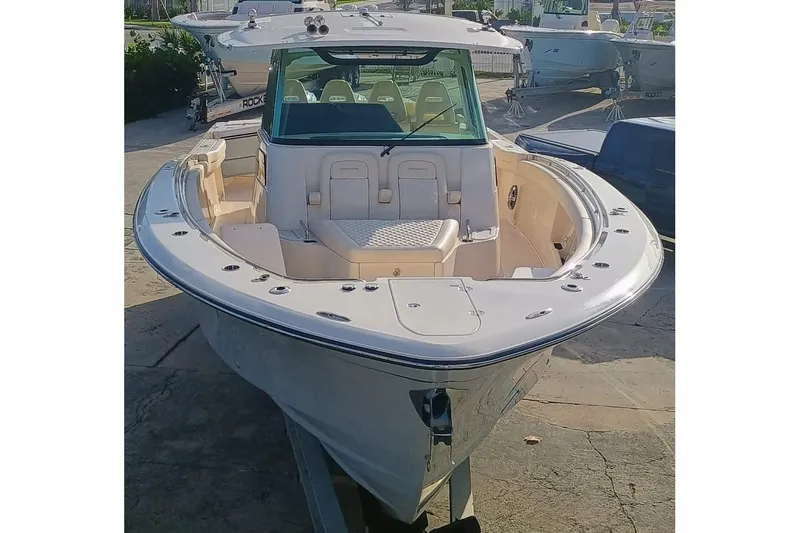 Slide: The Image of 2025 Grady-White Canyon 386 boat, front view, docked outdoors. - 2