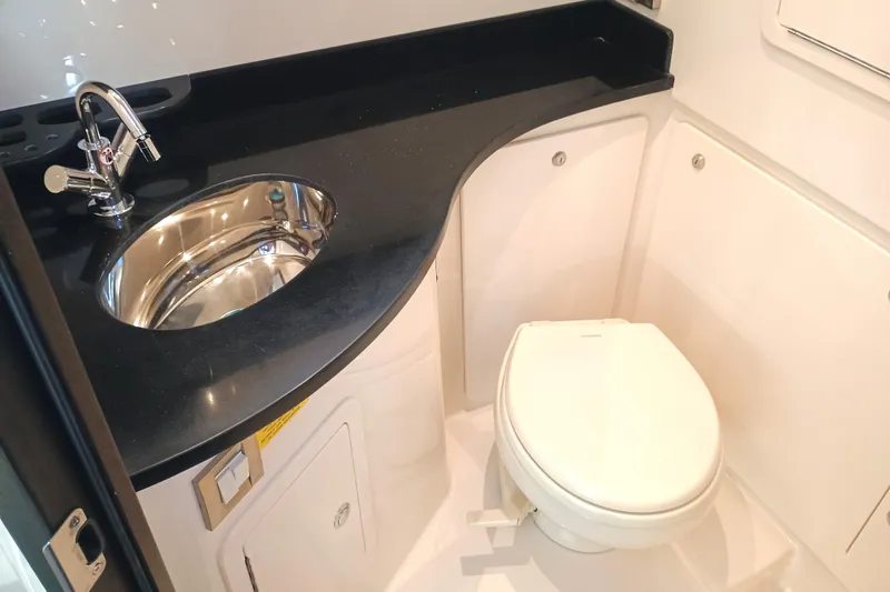 Slide: The Image of 2025 Grady-White Canyon 386 boat bathroom with sleek sink and modern toilet. - 25