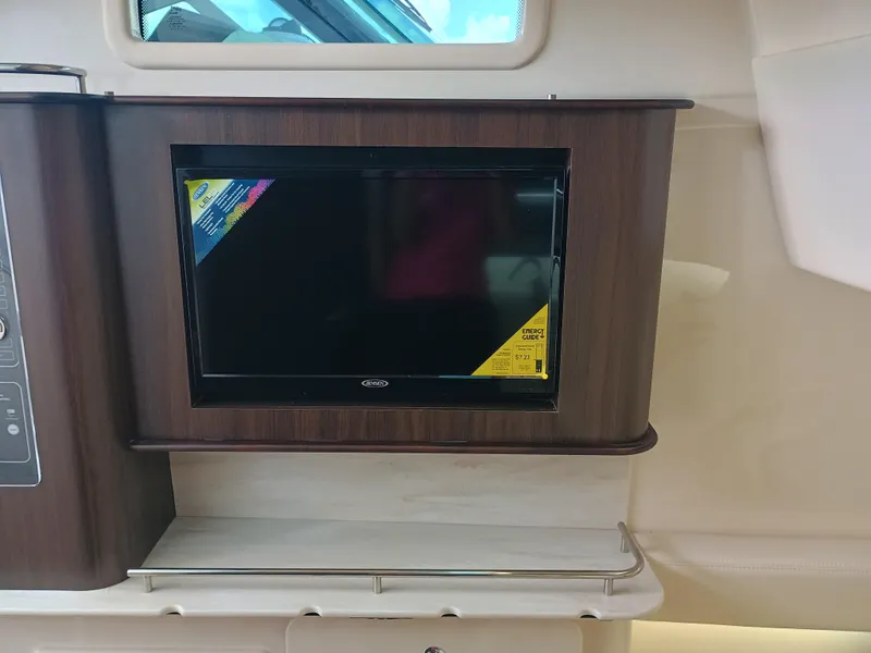 Slide: The Image of 2025 Grady-White Canyon 386 interior with built-in TV and wood paneling. - 29