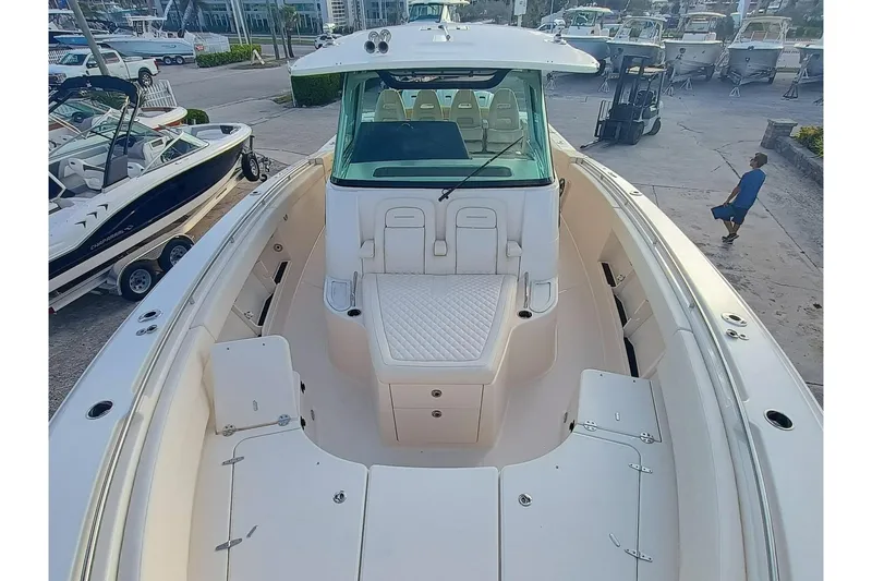 Slide: The Image of 2025 Grady-White Canyon 386 boat, spacious deck, docked at marina. - 3
