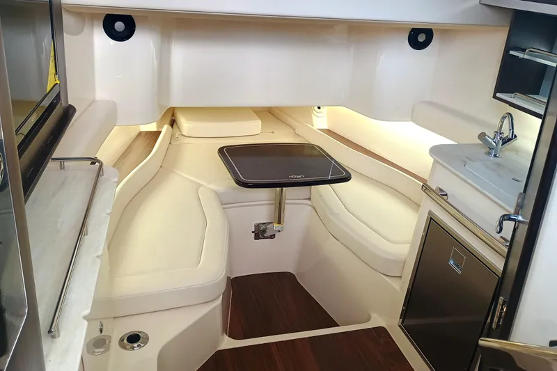 Slide: The Image of 2025 Grady-White Canyon 386 cabin interior with seating, table, and kitchenette. - 30