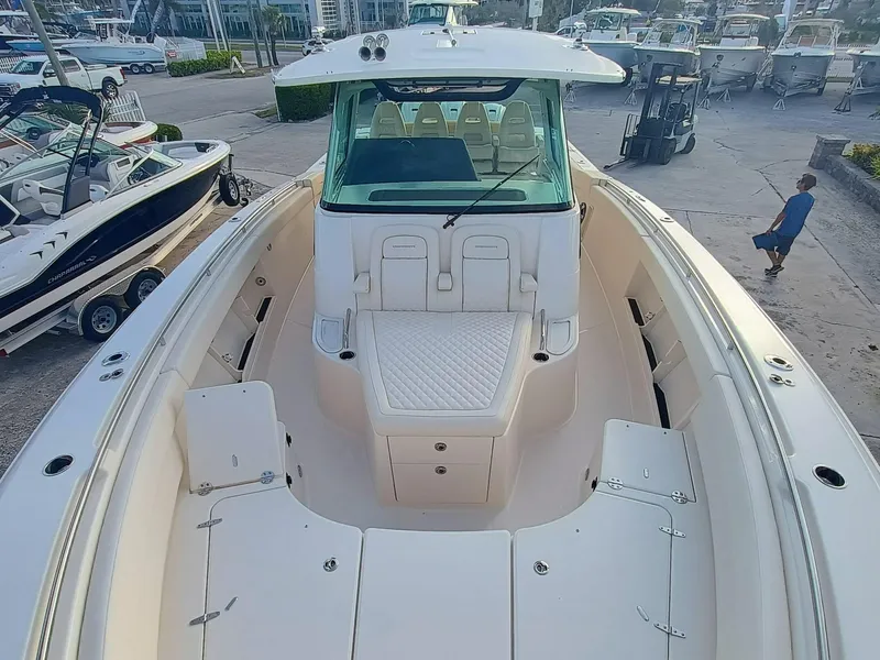 Slide: The Image of 2025 Grady-White Canyon 386 boat, spacious deck view, docked at marina. - 4