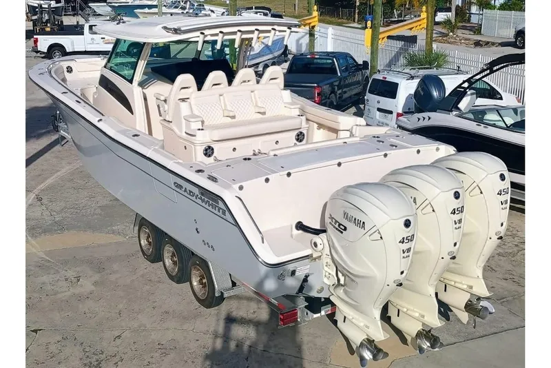 Slide: The Image of 2025 Grady-White Canyon 386 boat with triple Yamaha 450 engines on a trailer. - 6