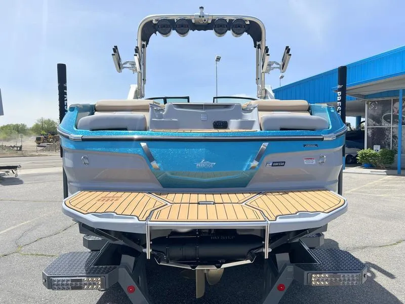 Slide: The Image of 2023 MasterCraft X24 boat, rear view, showcasing teak swim platform and sleek design. - 22