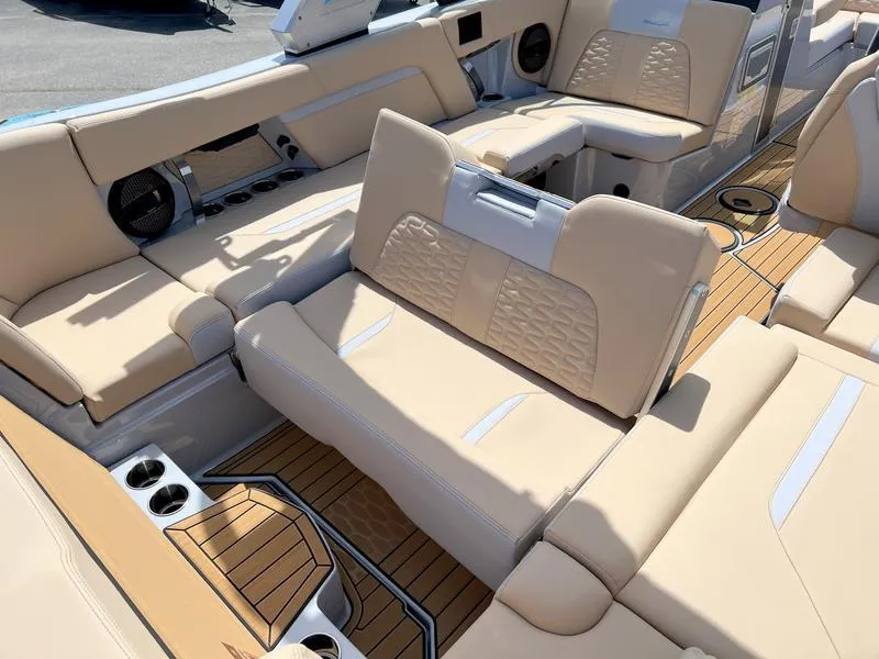 Slide: The Image of 2023 MasterCraft X24 boat interior with beige seating and teak flooring. - 31
