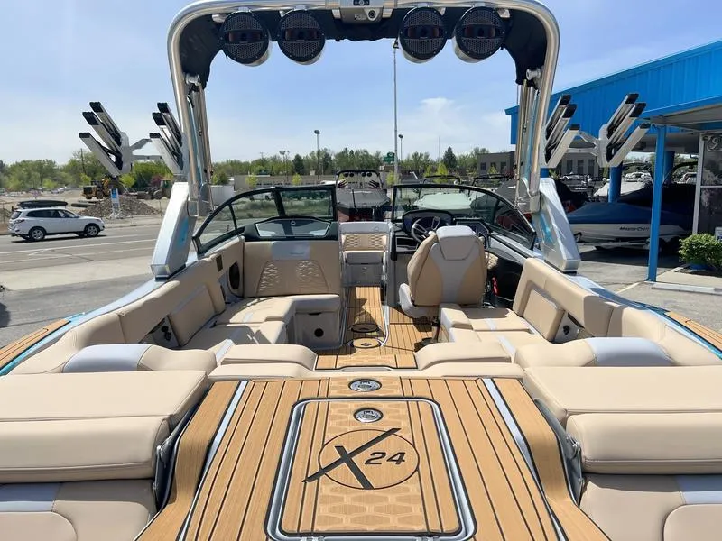 Slide: The Image of 2023 MasterCraft X24 boat interior with luxurious seating and advanced sound system. - 39