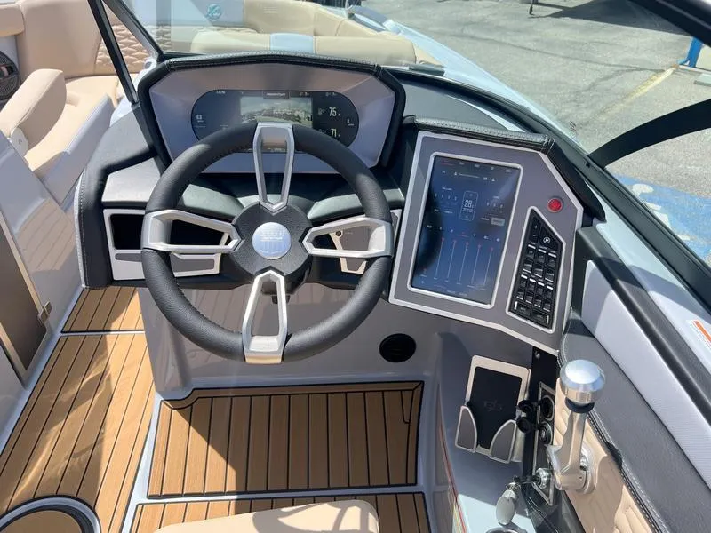 Slide: The Image of 2023 MasterCraft X24 boat dashboard with steering wheel and digital controls. - 43