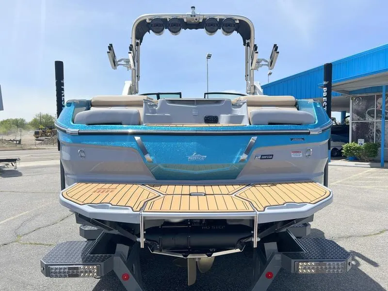 Slide: The Image of 2023 MasterCraft X24 boat, rear view, showcasing sleek design and spacious deck. - 6