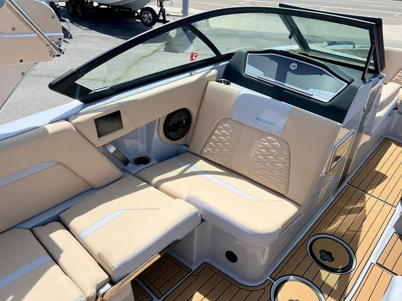 Slide: The Image of 2023 MasterCraft X24 boat interior with beige seating and sleek design. - 9