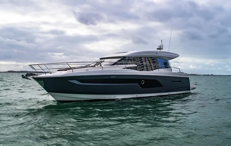 The Image of 2024 Prestige 520S yacht cruising on open water under cloudy skies. - 0