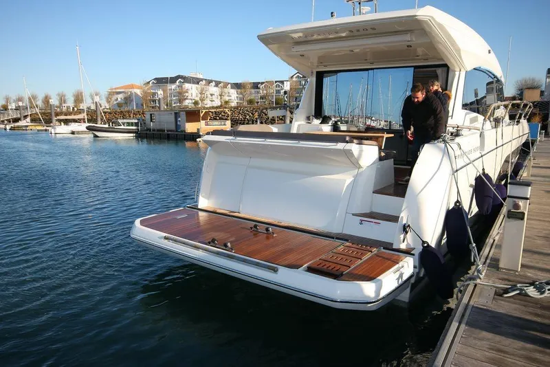 Slide: The Image of 2024 Prestige 520S yacht docked at marina, featuring spacious deck and modern design. - 3