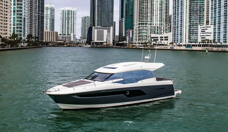 Slide: The Image of 2024 Prestige 520S yacht cruising in urban waterfront setting. - 8