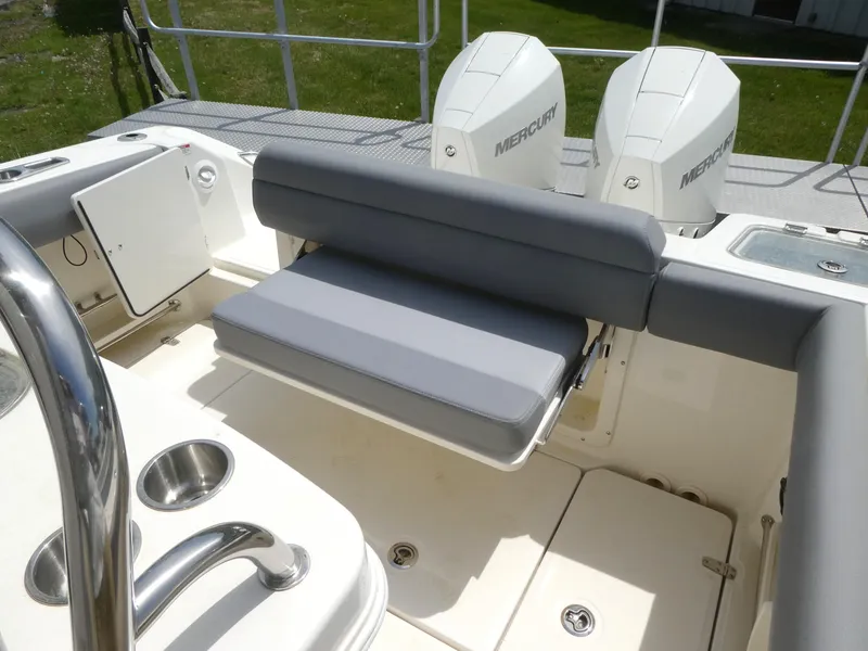 Slide: The Image of 2025 Boston Whaler 250 Outrage boat interior with seating and dual Mercury engines. - 10