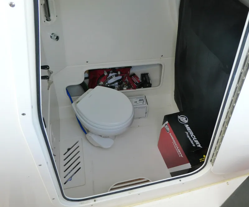 Slide: The Image of Interior of 2025 Boston Whaler 250 Outrage boat with storage and marine toilet. - 16