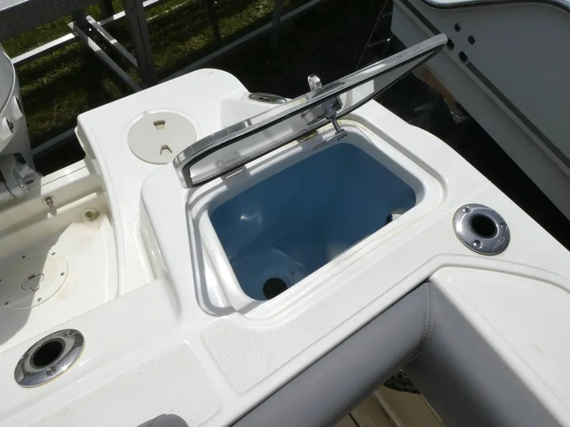 Slide: The Image of Livewell on 2025 Boston Whaler 250 Outrage boat, open lid, white and blue interior. - 8