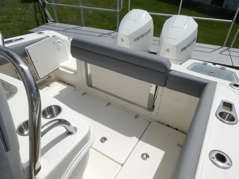 Slide: The Image of 2025 Boston Whaler 250 Outrage boat interior with dual Mercury engines and seating area. - 9