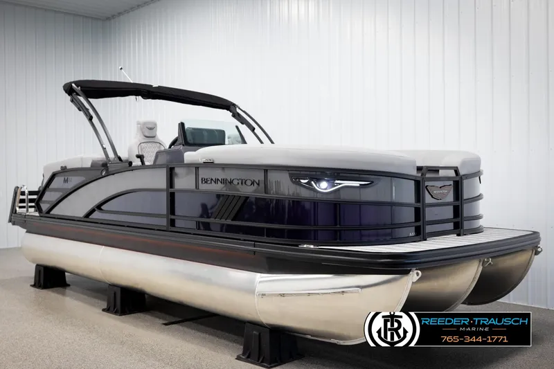 Slide: The Image of 2025 Bennington 22 MFBSE pontoon boat in showroom, sleek design, modern features. - 2