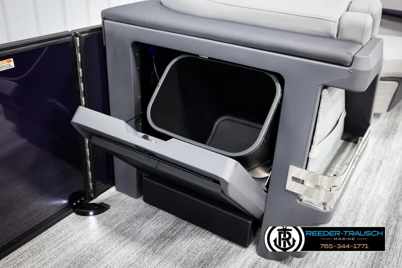 Slide: The Image of 2025 Bennington 22 MFBSE boat storage compartment with open lid, showcasing interior space. - 24