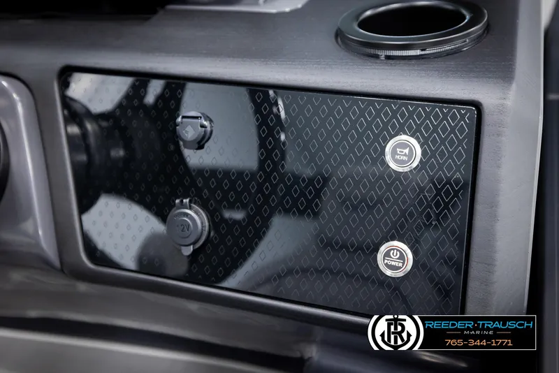 Slide: The Image of Dashboard of 2025 Bennington 22 MFBSE with control buttons and cup holder. - 32