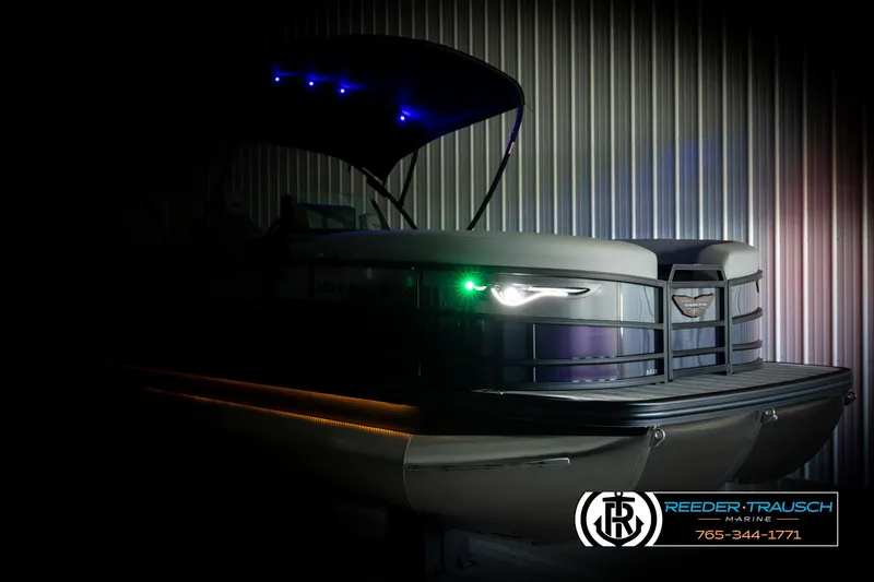 Slide: The Image of 2025 Bennington 22 MFBSE pontoon boat with illuminated lights in a dimly lit setting. - 4