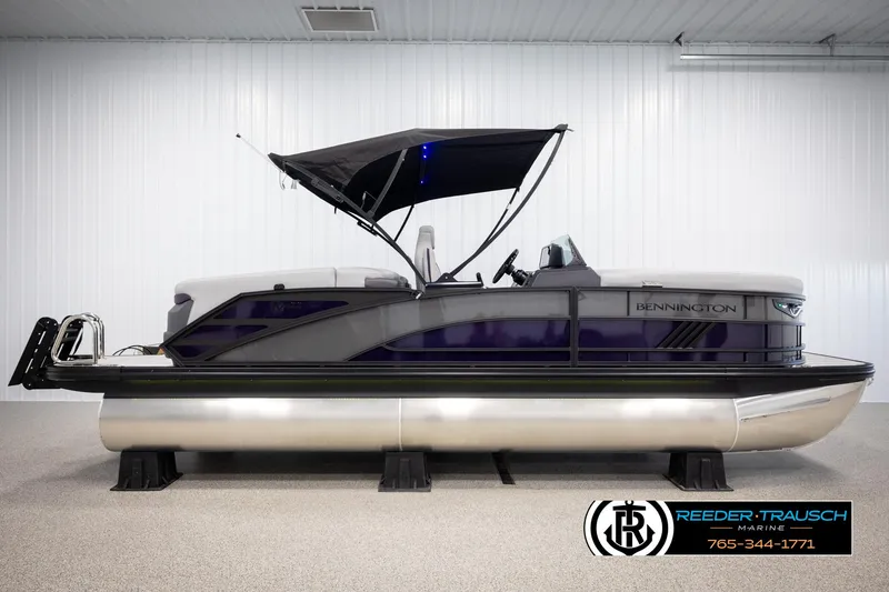 Slide: The Image of 2025 Bennington 22 MFBSE pontoon boat with canopy in showroom setting. - 5