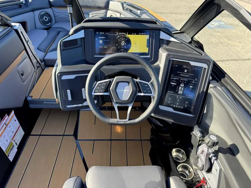 Slide: The Image of 2025 Supra SL boat cockpit with modern steering wheel and digital displays. - 12