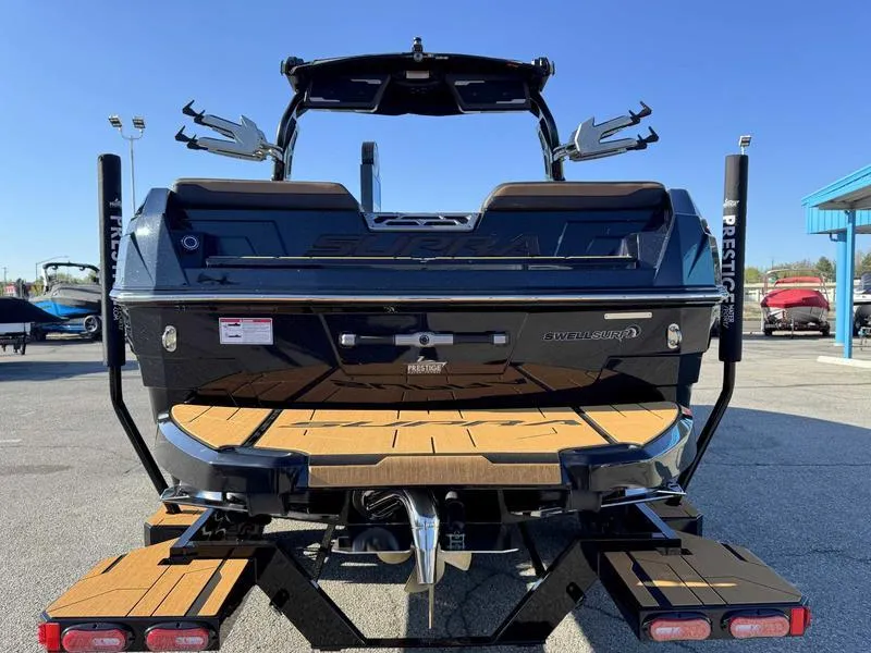 Slide: The Image of 2025 Supra SL boat, rear view, showcasing sleek design and wooden deck details. - 8